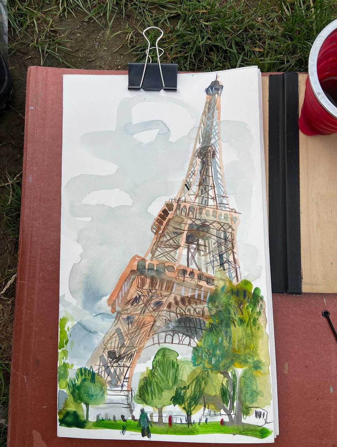 Watercolour and pencil drawing of the Eiffel Tower in a sketchbook by Swasky