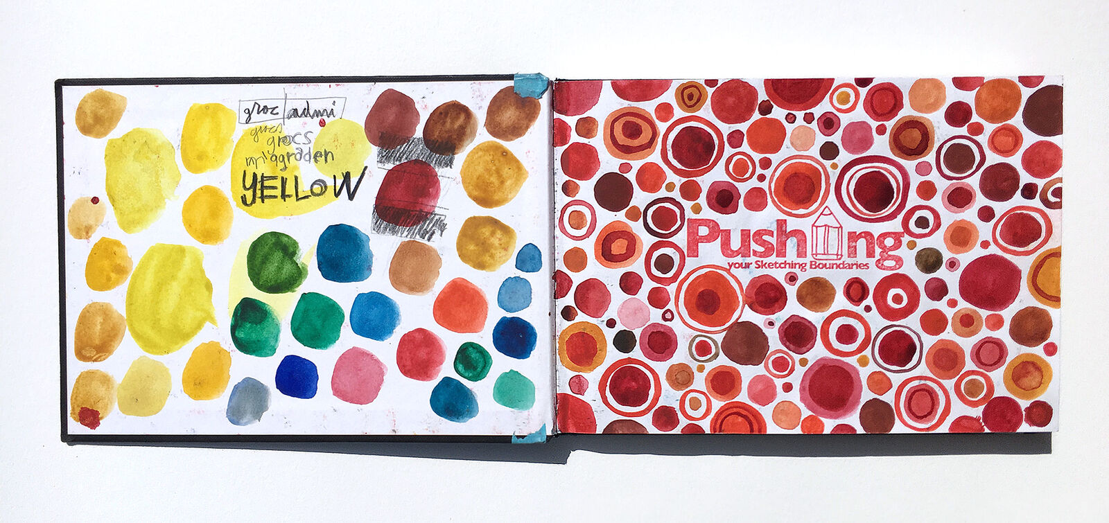 Open sketchbook with yellow colour tests and a red circular pattern study by Swasky