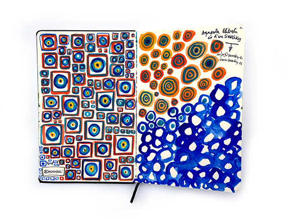 Open sketchbook with blue, orange and yellow pattern studies by Swasky